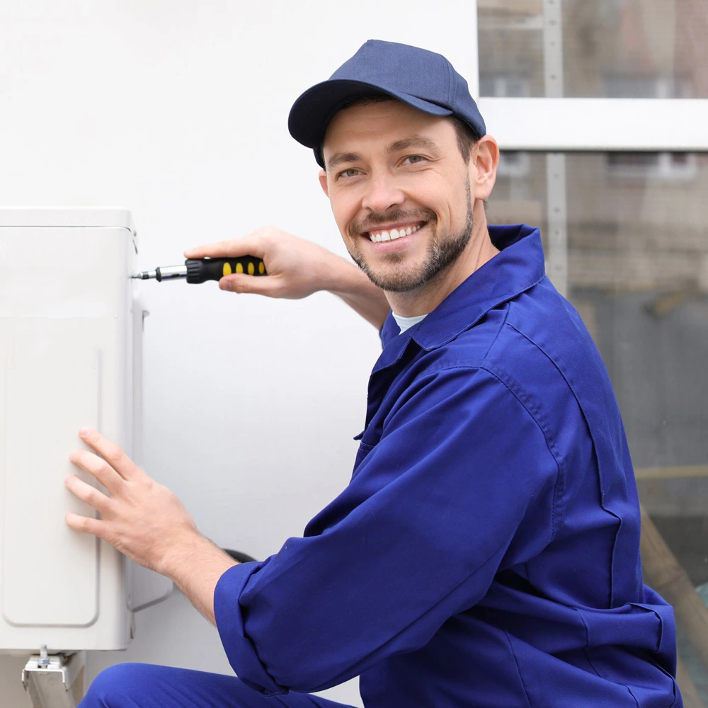 male working on AC and smiling